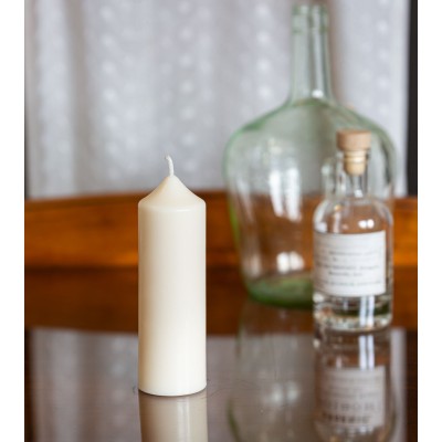 Bougie artisanale en cire naturelle de colza Ø 5 cm H 14 cm posée sur une table en verre