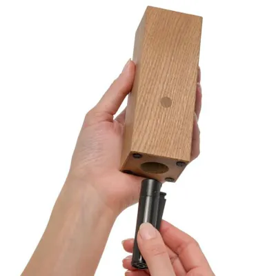 Bougeoir en chêne avec le briquet en main pour utilisation.